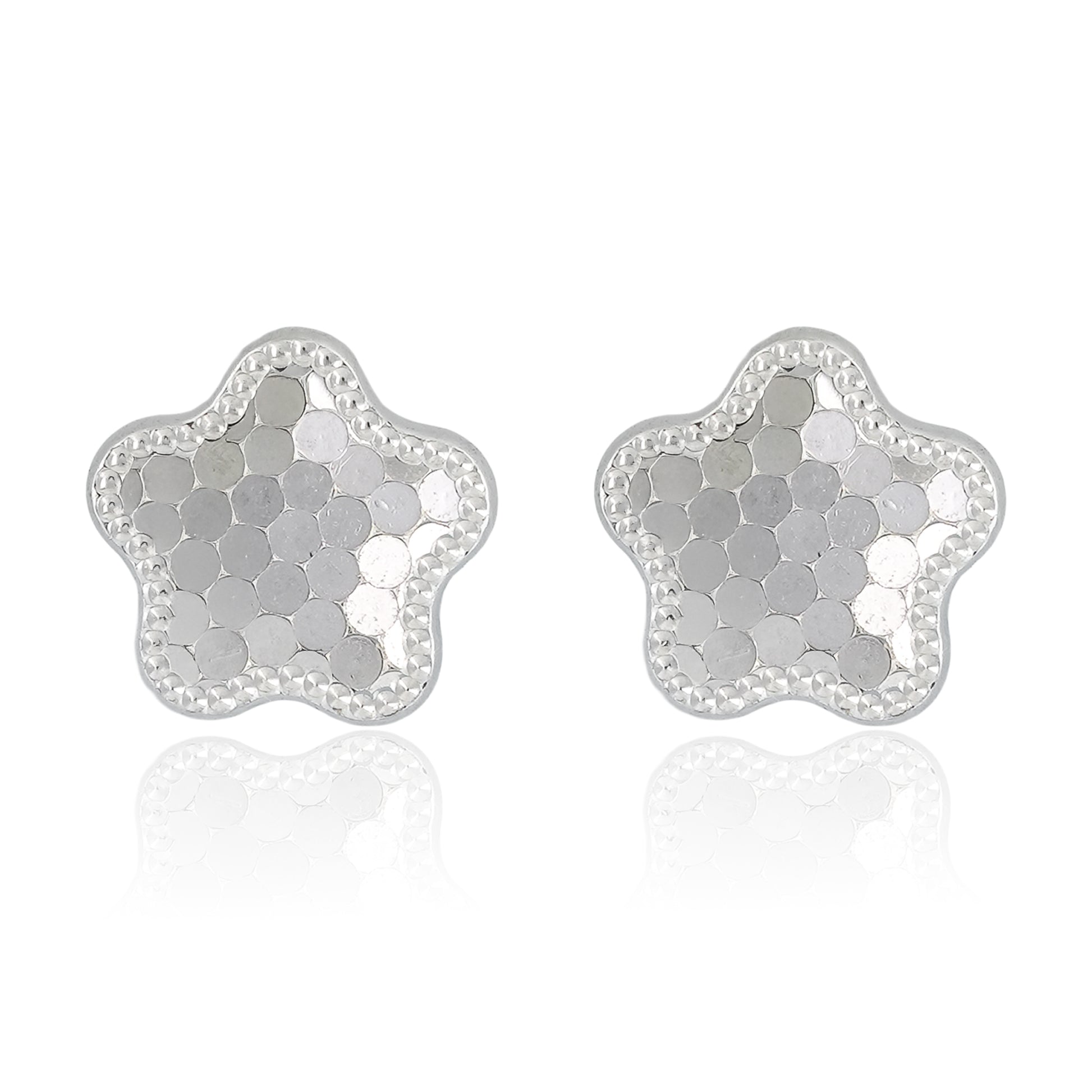 Close-up of Stardust Bloom Stud Earrings featuring star-flower shaped studs with hexagonal textured facets and a beaded border in polished sterling silver.