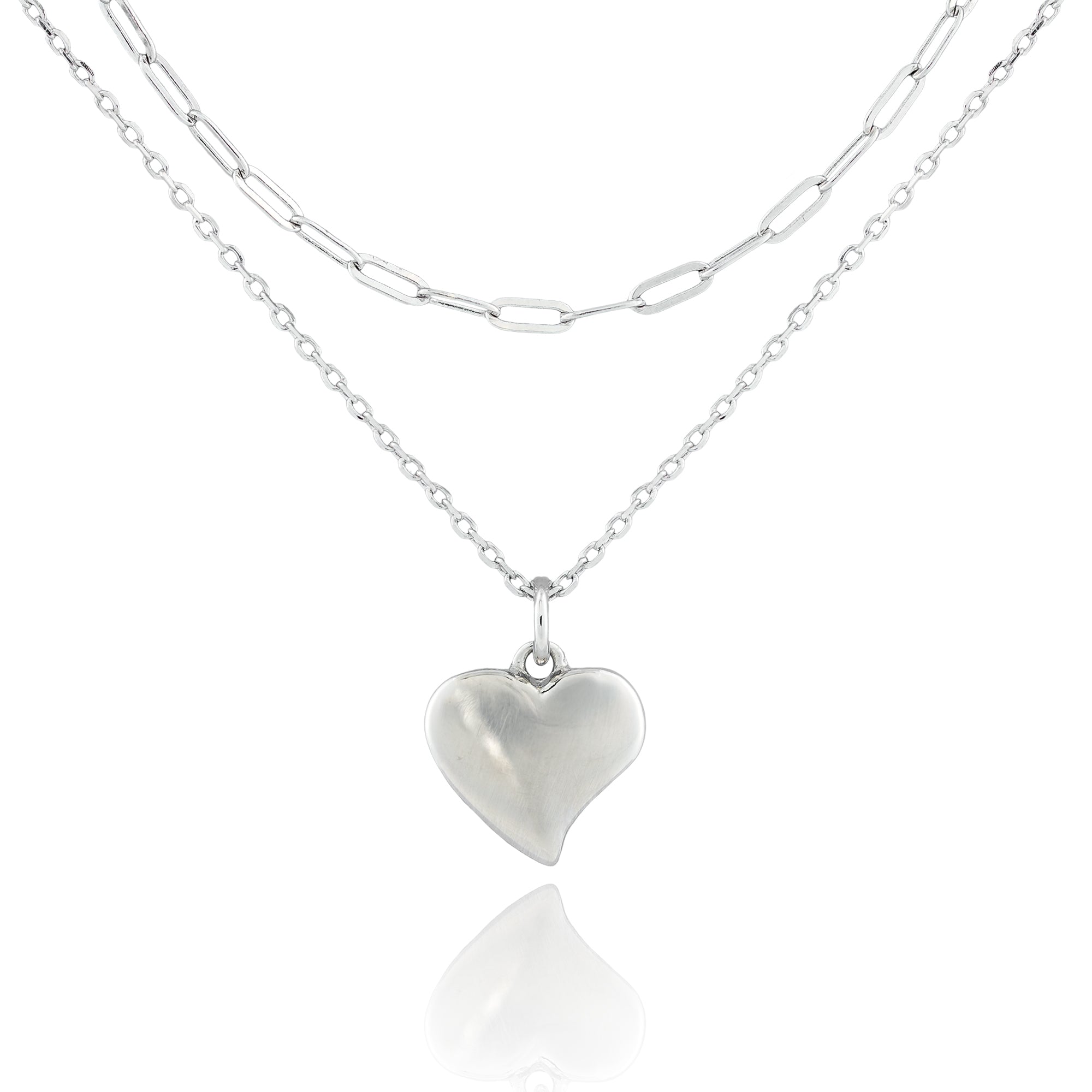 Close-up of the Sweetheart’s Love Necklace with a puffed heart pendant on dual sterling silver chains, featuring classic and paperclip link styles.