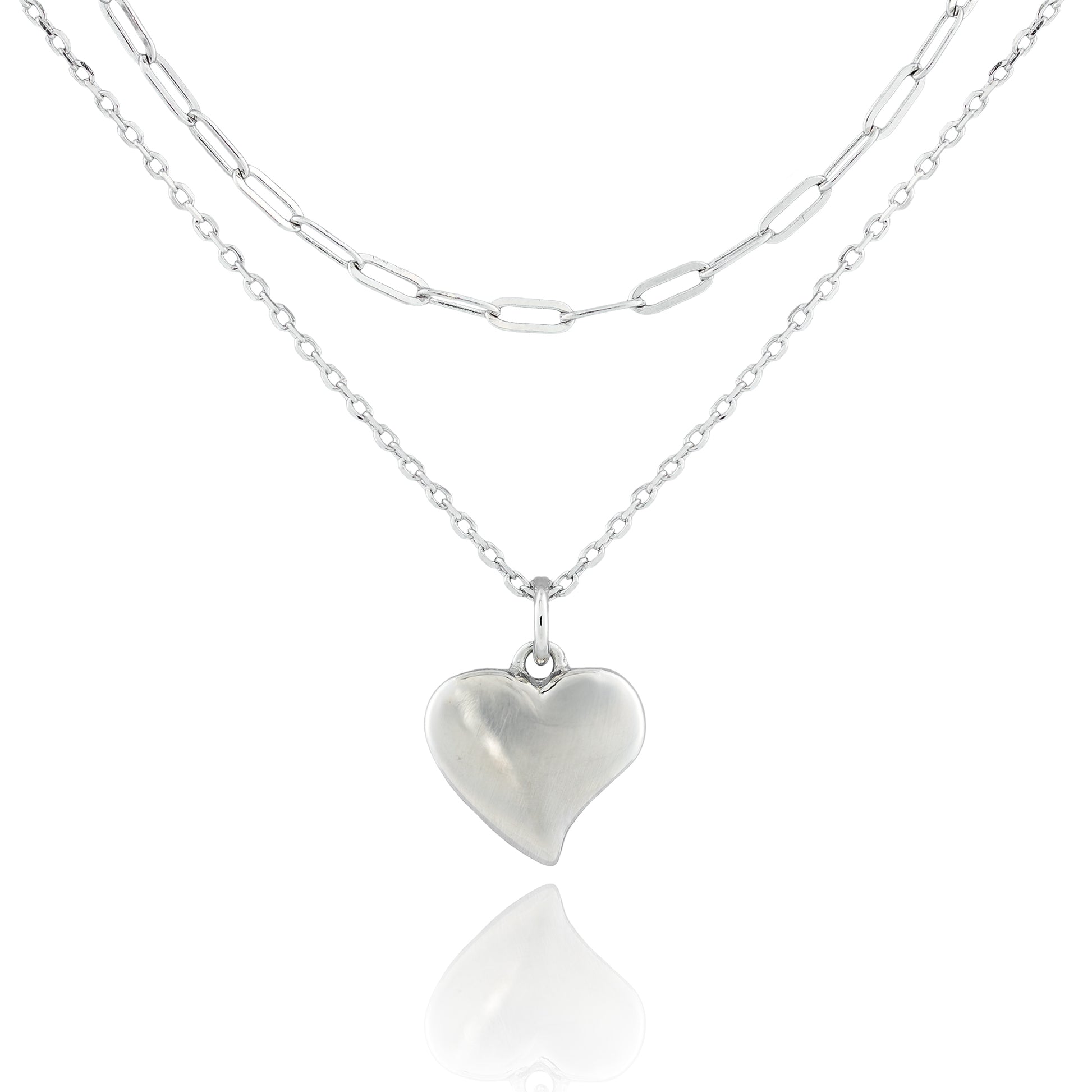 Close-up of the Sweetheart’s Love Necklace with a puffed heart pendant on dual sterling silver chains, featuring classic and paperclip link styles.