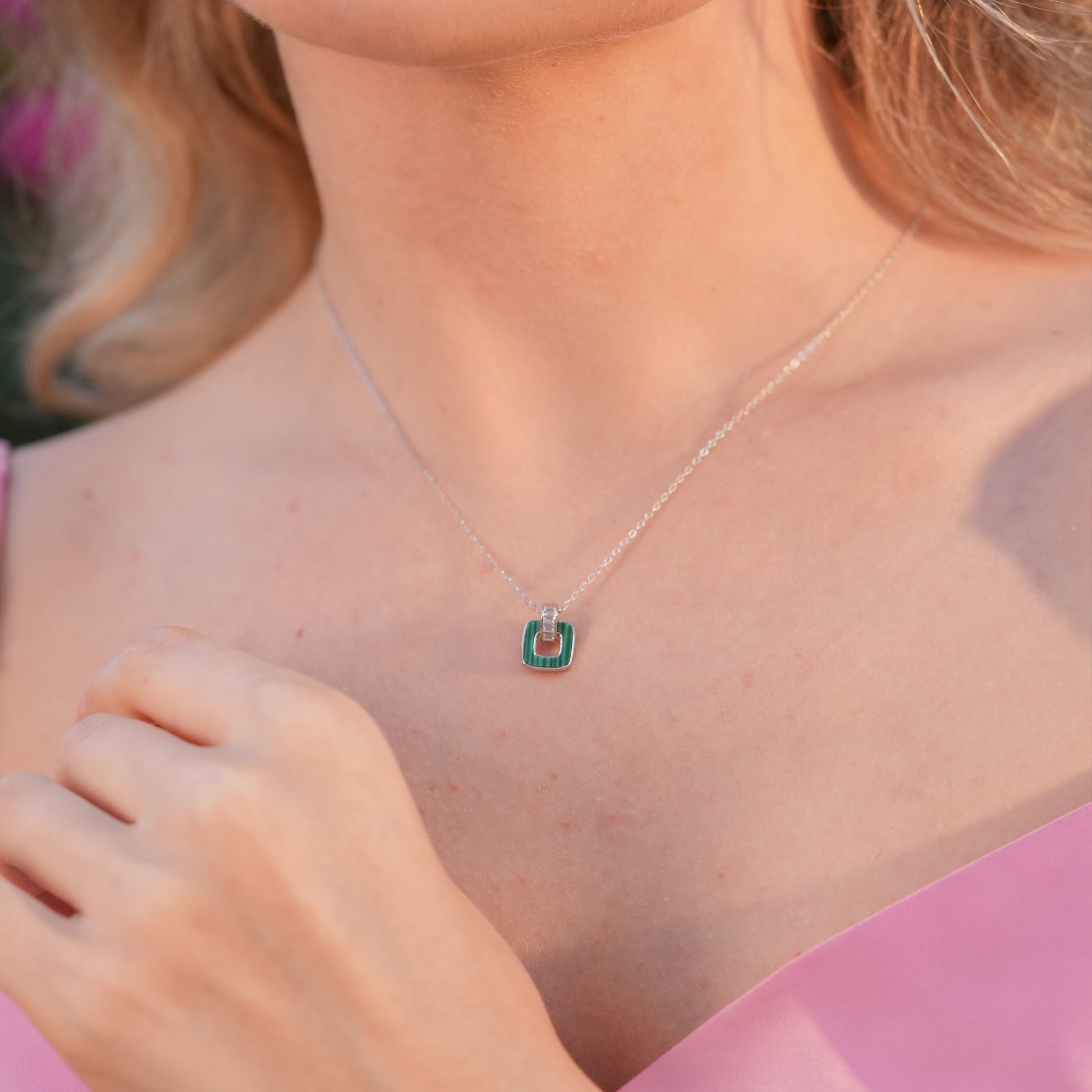 Model wearing the Malachite Square Necklace with a natural green malachite inlay pendant on a fine silver chain.