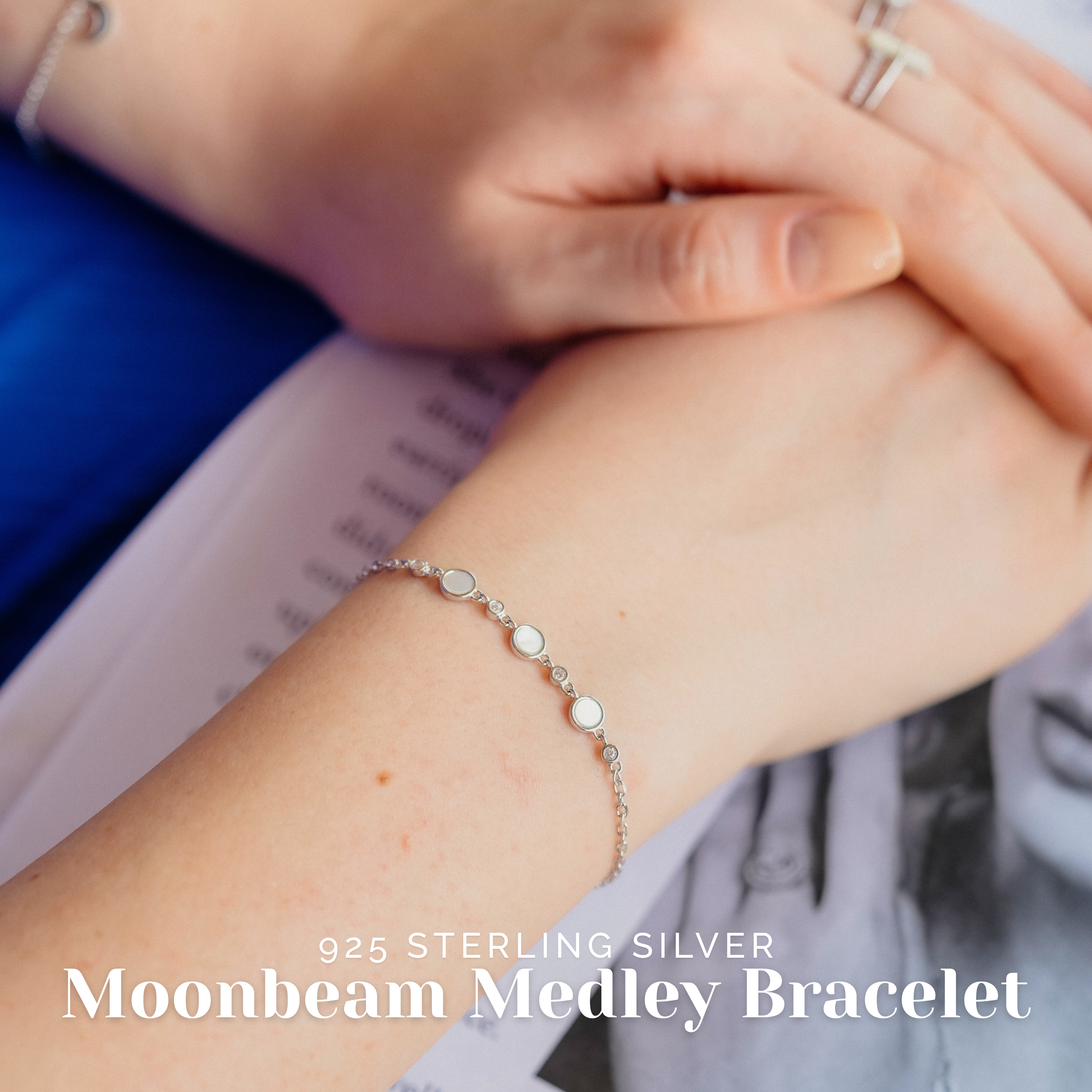 Elegant woman wearing sterling silver moonbeam bracelet styled with a pastel outfit