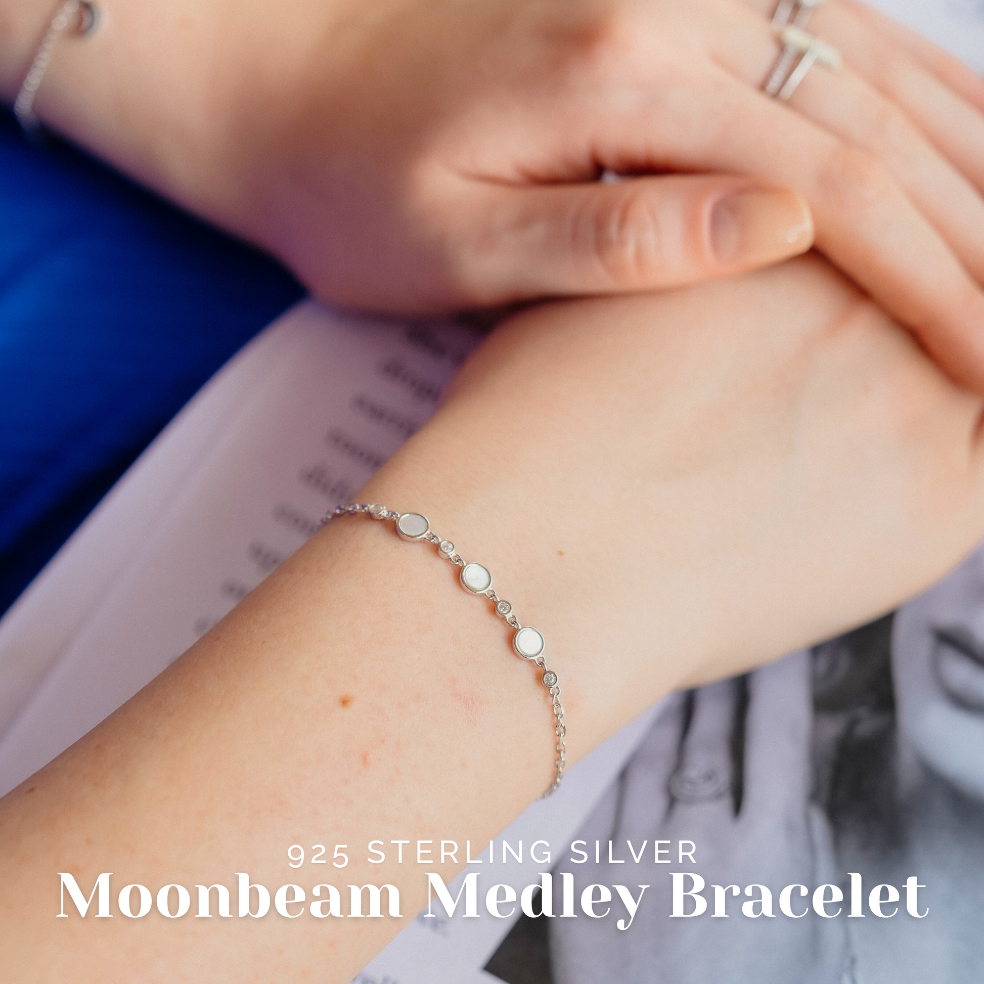 Elegant woman wearing sterling silver moonbeam bracelet styled with a pastel outfit