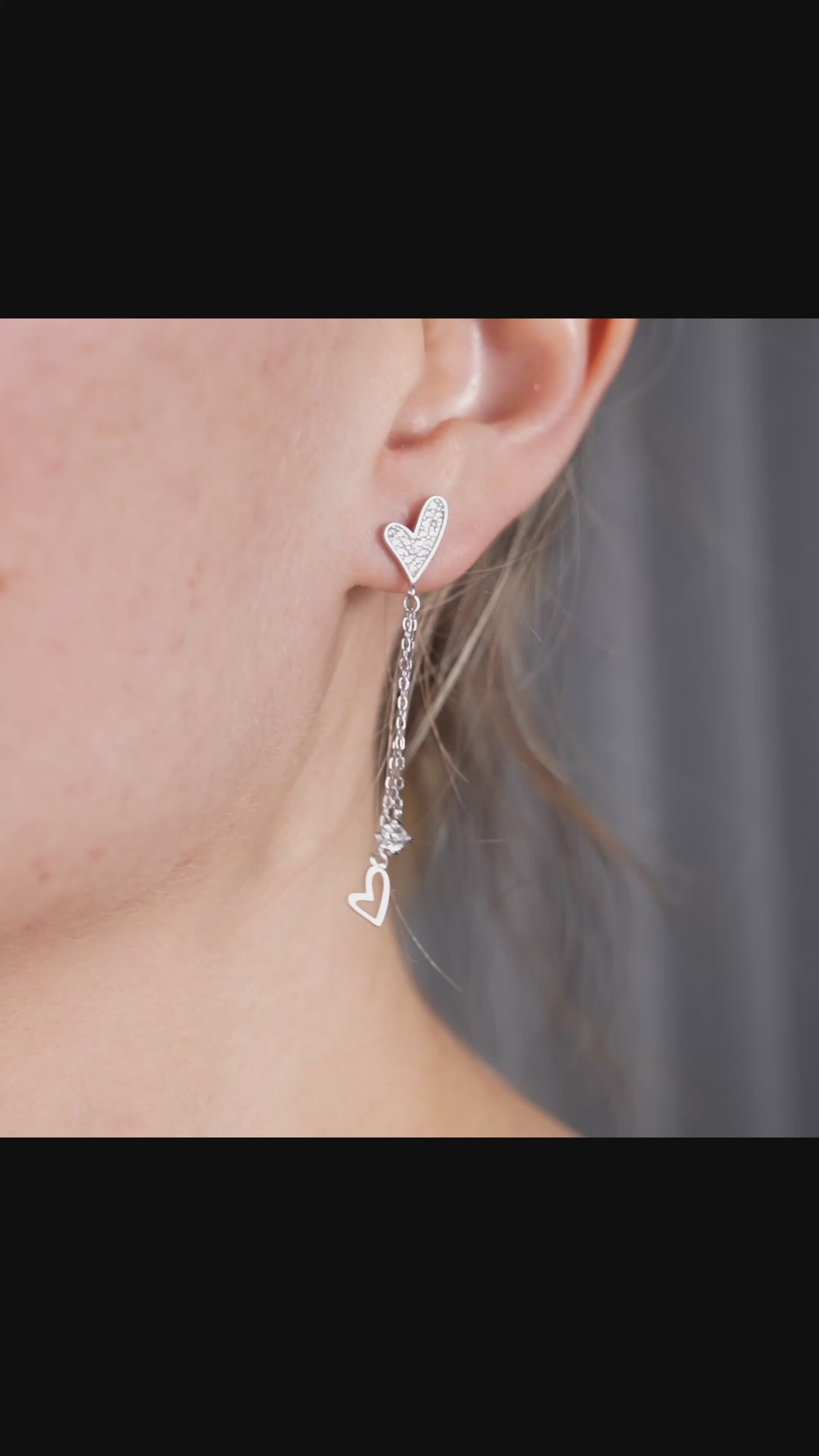 video view of sterling silver dangle earrings featuring cubic zirconia accents and delicate drop chains, displayed on a minimal studio background.