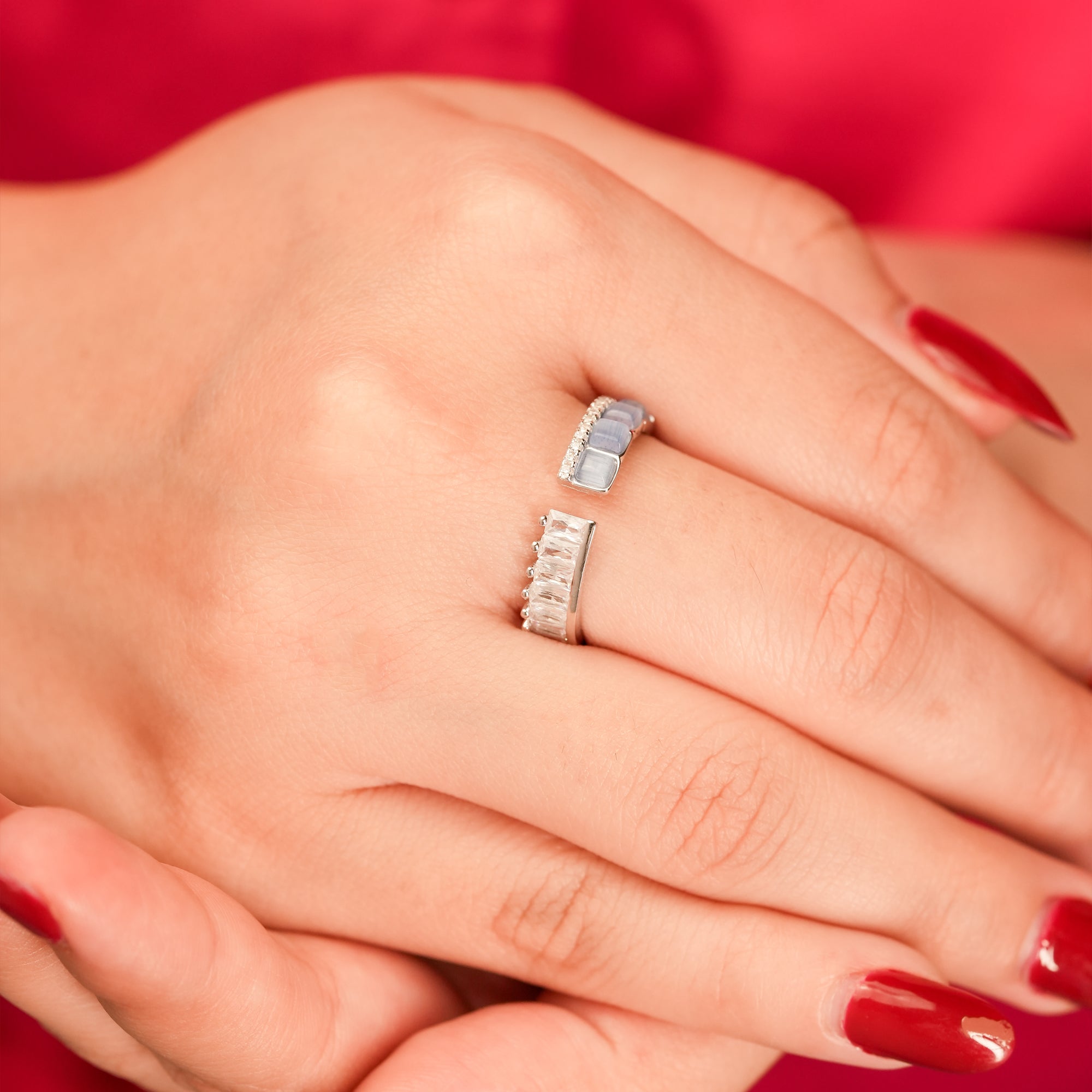 Close-up of a hand wearing open band silver ring