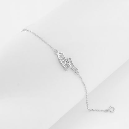 Close-up of Dual Curve Spark Bracelet featuring two curved silver bars with princess-cut and pavé cubic zirconia on a delicate sterling silver chain.