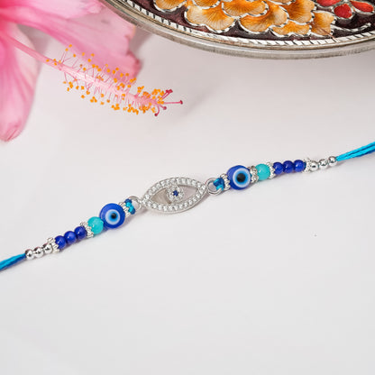 925 silver rakhi with blue and white evil eye design on adjustable thread.