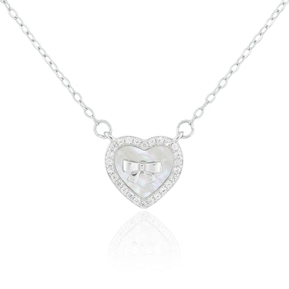 Close-up of the Heart of Grace Necklace featuring a mother-of-pearl heart pendant framed with a crystal halo and delicate silver bow.