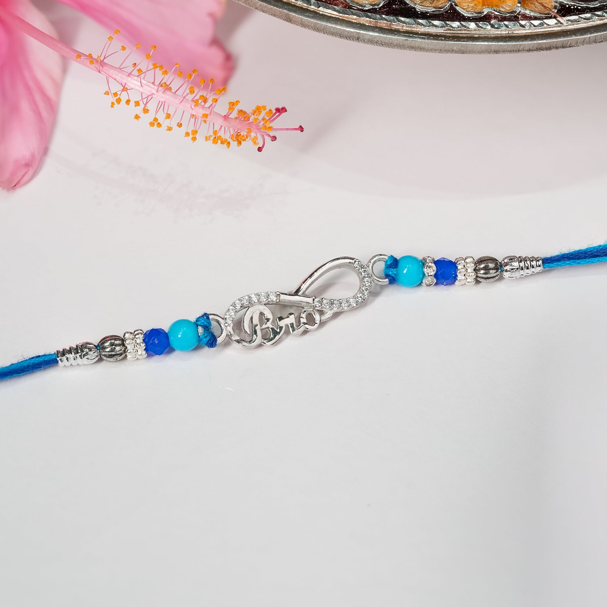 Bracelet with blue beads and silver clasp on a white background