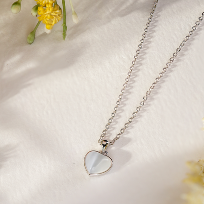 Close-up of the Solene Classic Heart Necklace, featuring a smooth high-polish heart pendant on a textured sterling silver chain.