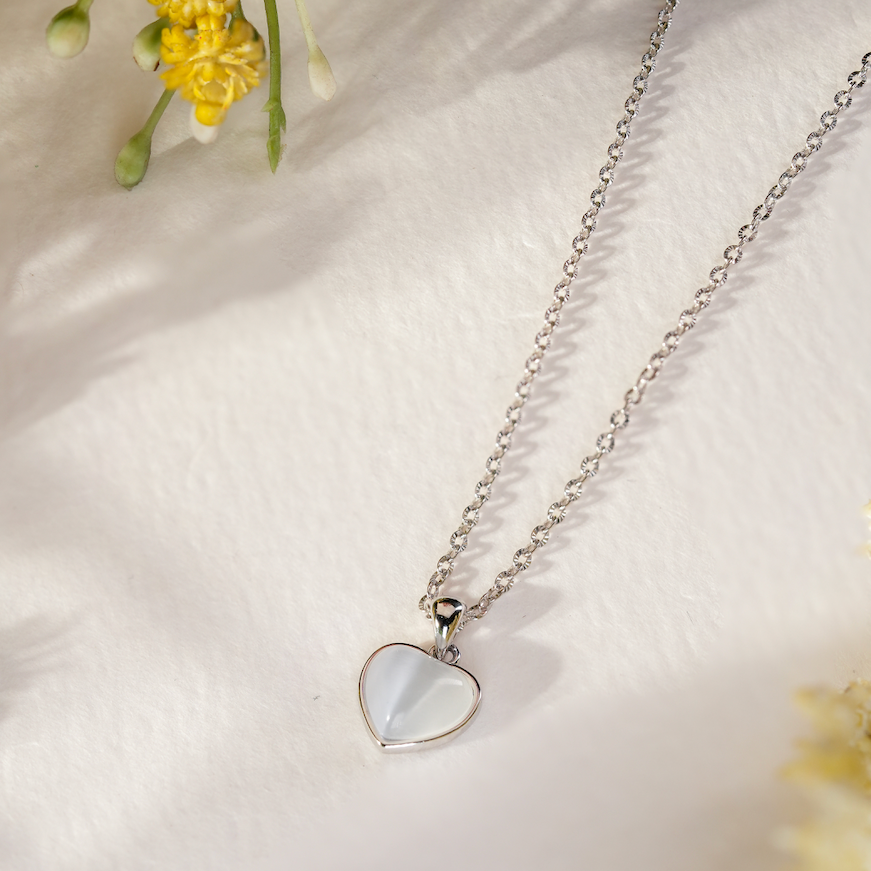 Close-up of the Solene Classic Heart Necklace, featuring a smooth high-polish heart pendant on a textured sterling silver chain.