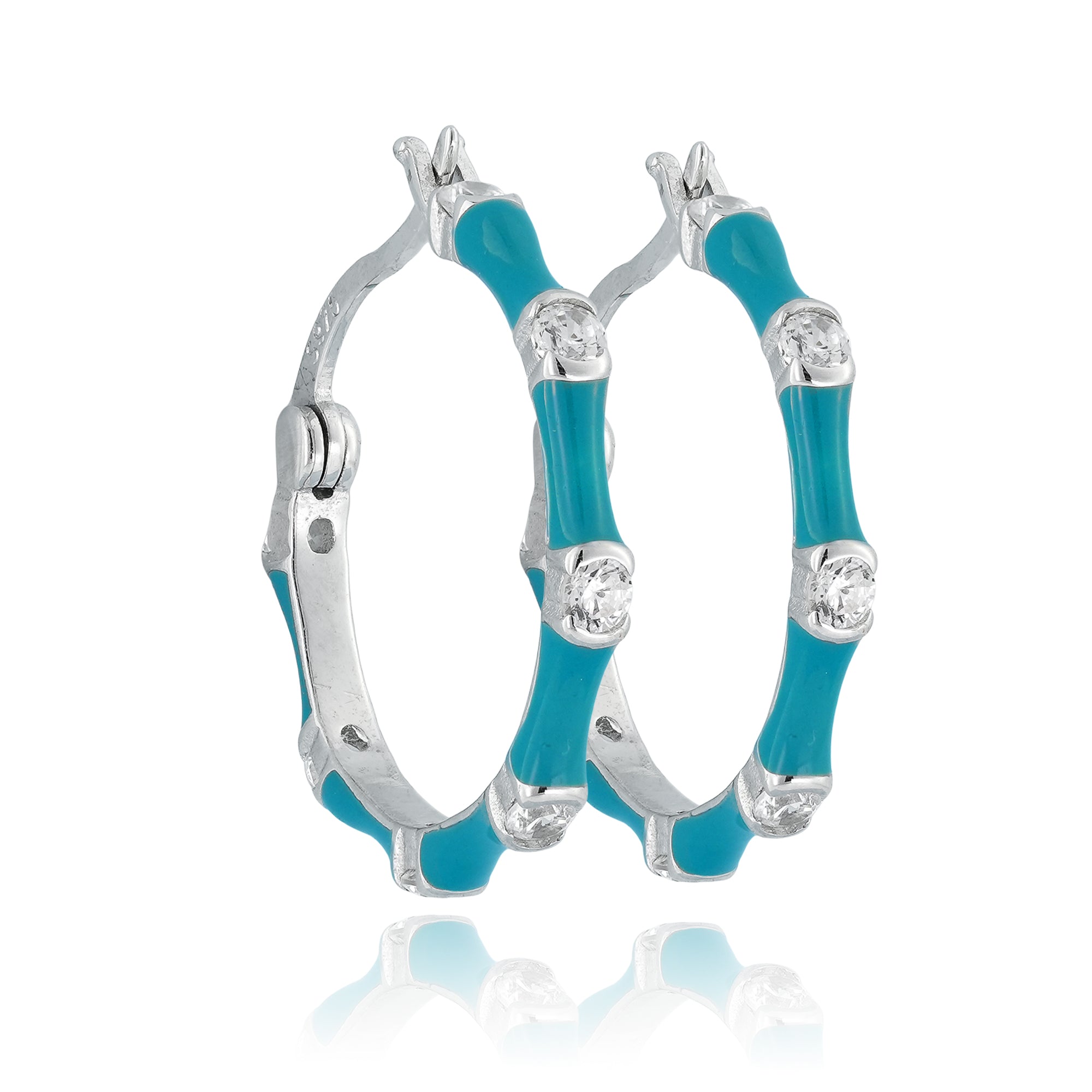 Silver-toned half-hoop earrings with turquoise enamel and cubic zirconia displayed on a minimal background.